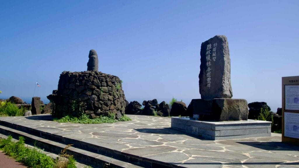 Stone monuments on a seaside plaza near Sindo.