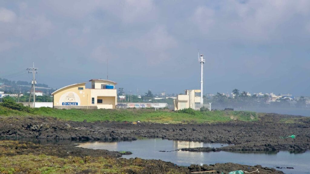 Coastal police post and tower by tide pools near Yeongnak.