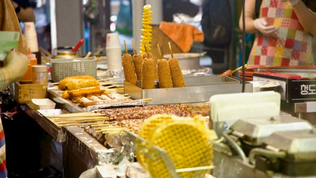 Corn dogs and a tornado potato at a snack stall.