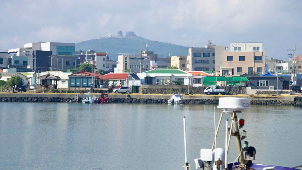 Moseulpo harbor with townfront and a domed hill beyond.