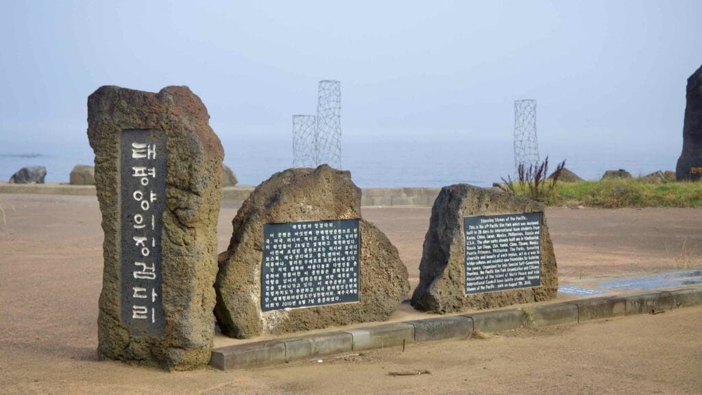 Basalt stone monuments stand beside the sea at Pan‑Pacific Peace Park.
