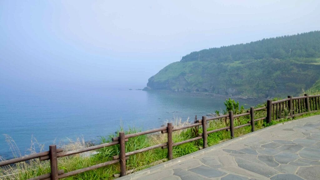 A misty view across the water to Songaksan’s layered cliffs and pine ridge.