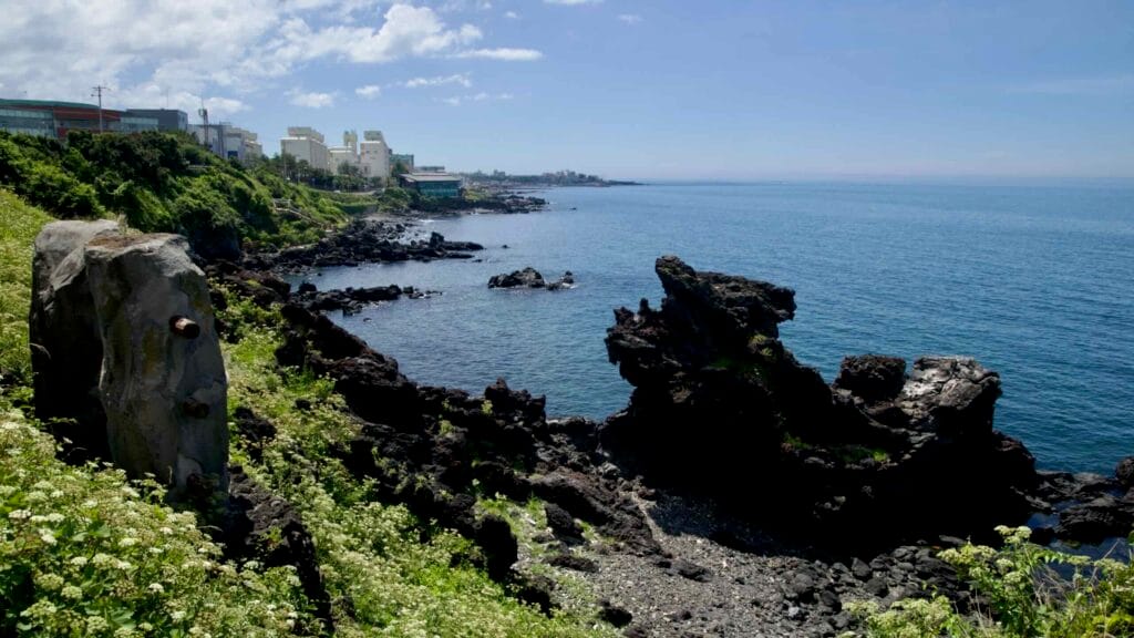 Basalt cliffs and lava rocks around Yongduam on Jeju’s coastline.