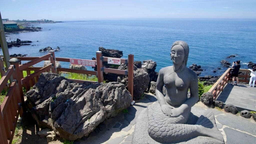 Mermaid statue and coastal lookout near Yongduam, Jeju City.