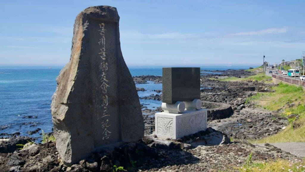 Paired memorial stones above basalt flats near Sasu Port.