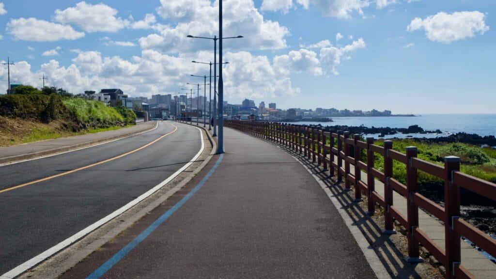 Coastal bike path skirting Jeju’s rocky shore.