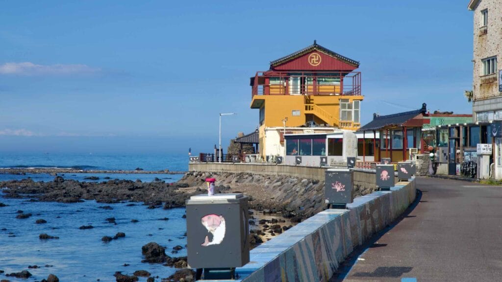 Daewonam temple above the rocky seawall.