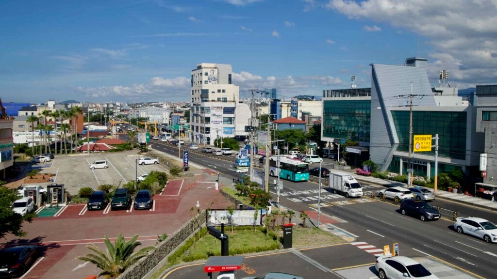 Rooftop view across Jeju City’s busy streets.