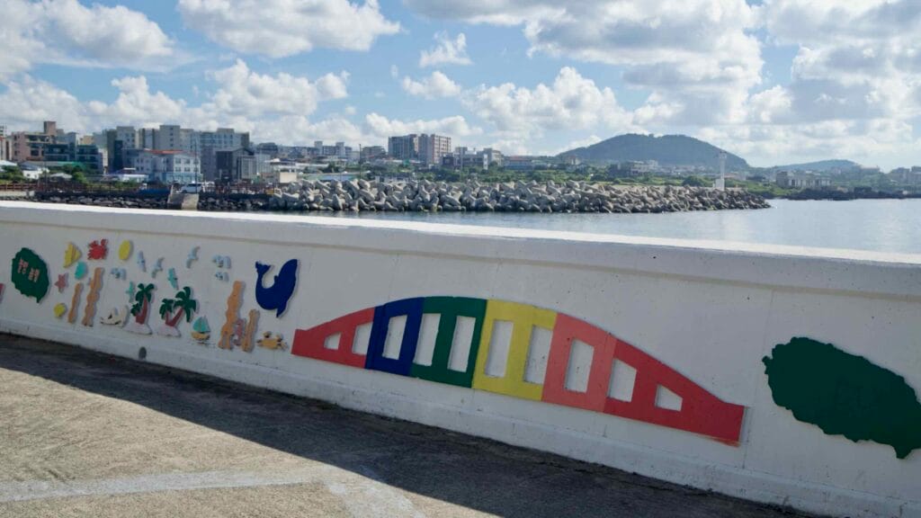 Colorful seawall art faces the harbor at Iho.