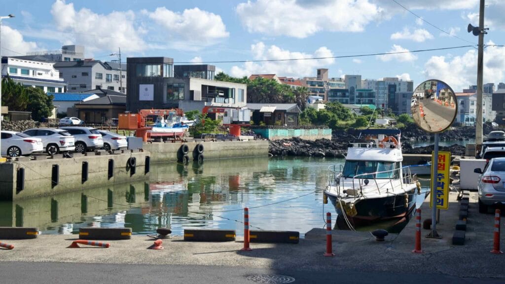 Boats moored in Iho Port with reflections on still water.