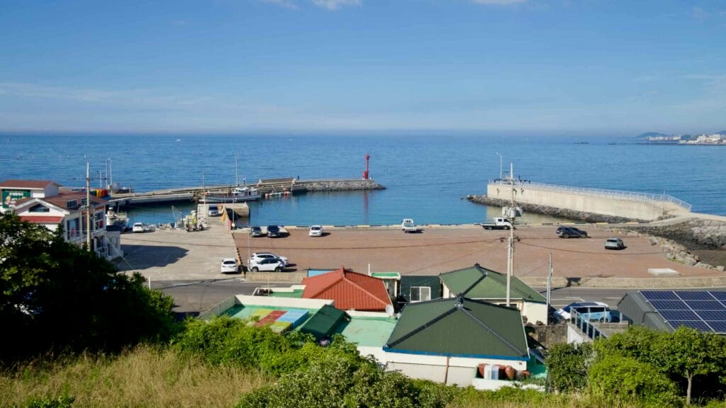 High view of Gamundong Port with red lighthouse on Jeju’s west coast.
