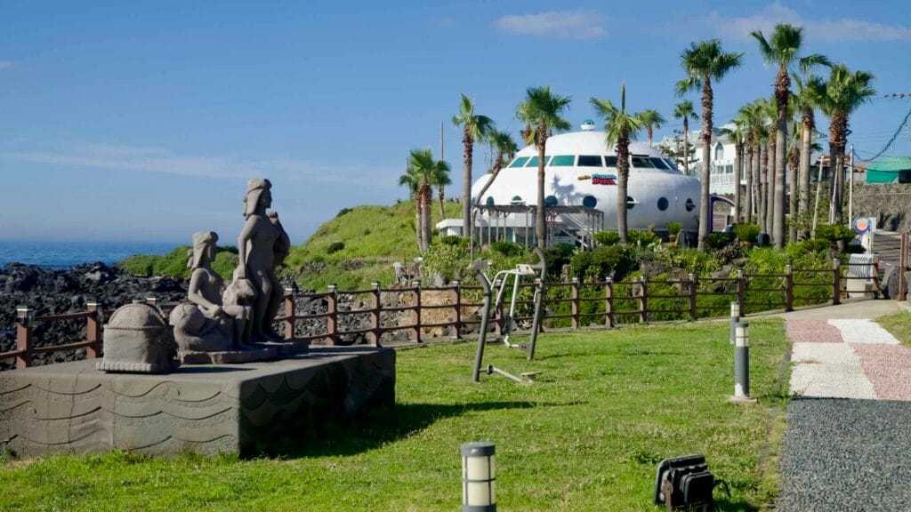 Sculpture and outdoor gym at Darak Coastal Park with the UFO‑shaped café nearby.
