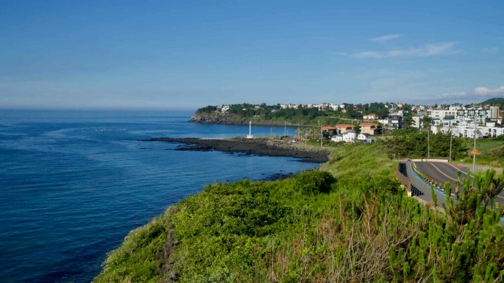 From a high bend in the Hagu‑Aewol coast, the shoreline leads toward Shineom Port.