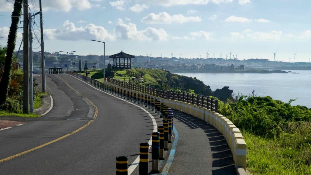 A bike lane curves along Hagu‑Aewol Coastal Road toward Darak Shelter.