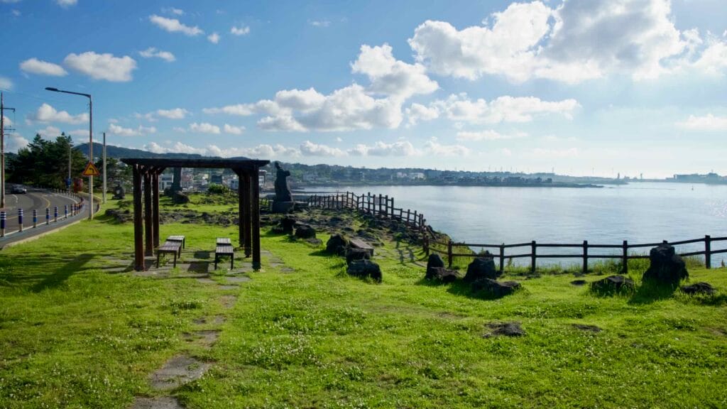 Grassy clifftop along the Hagu‑Aewol Coastal Road at Darak Shelter.