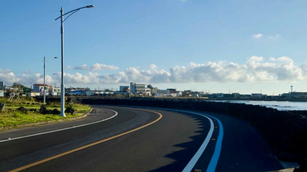 Hallimhaean‑ro curves along the seawall in Gwideok with a painted bike lane.
