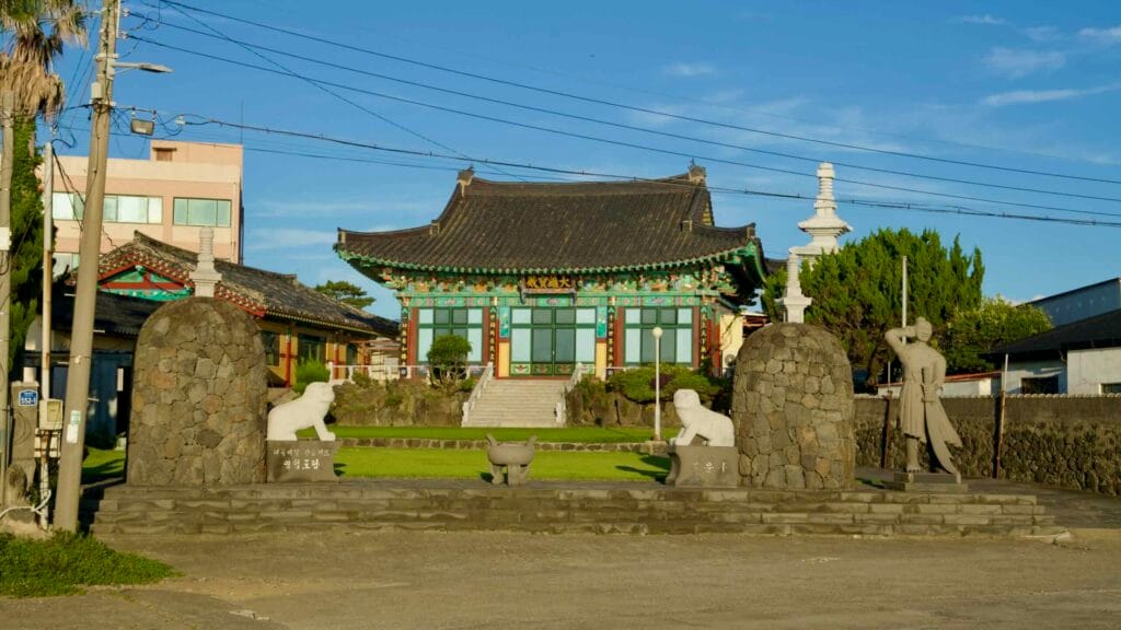 Main hall of Haewoon Temple with stone pagoda and guardian statues in Gwideok.