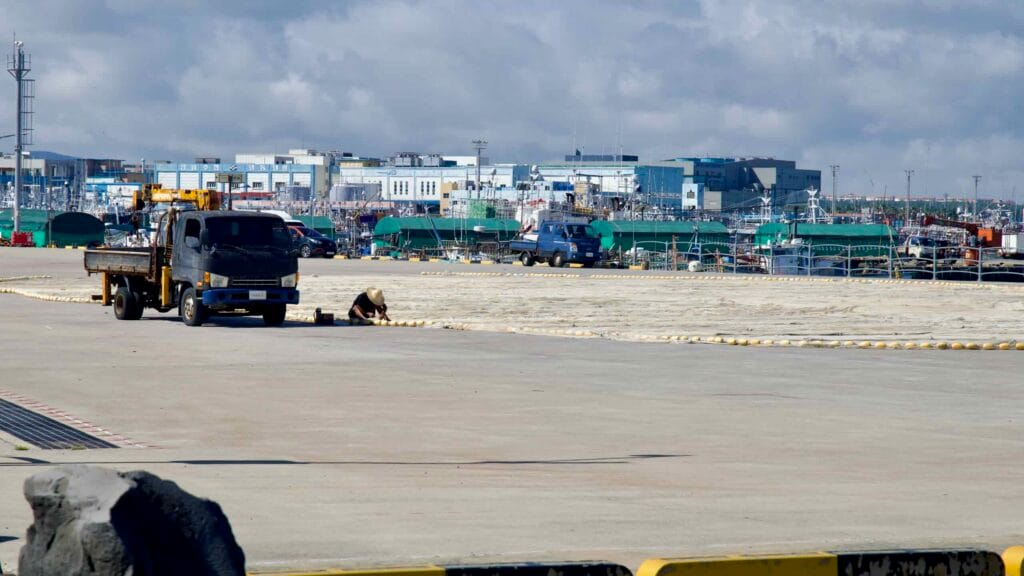 Hanlim Port’s work yard with trucks and a lone worker.