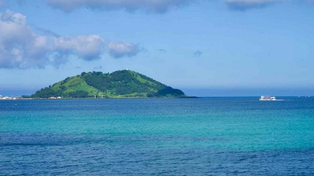 Passenger boat passes Biyangdo Island across the channel.