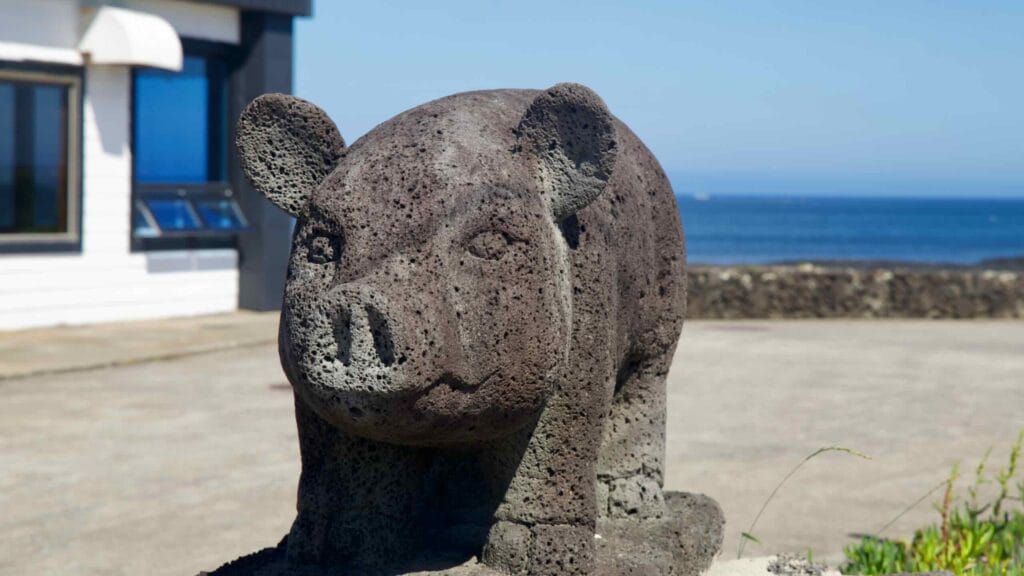 Basalt pig sculpture near the sea by Hanlim Port.