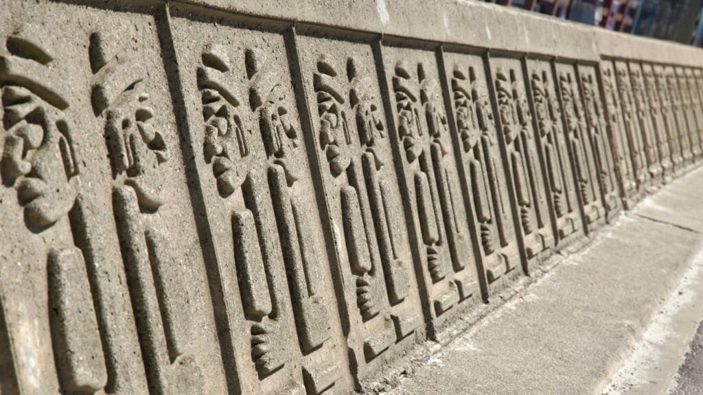 Dol hareubang relief panels along the Hyeopjae seawall.