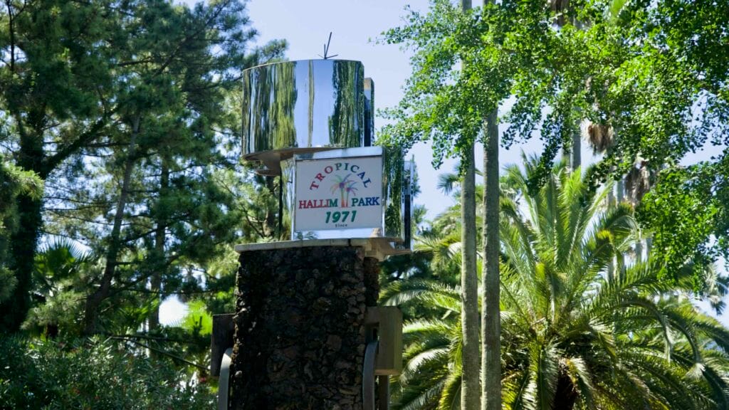 Stone pillar with “Tropical Hallim Park 1971” sign among palms.