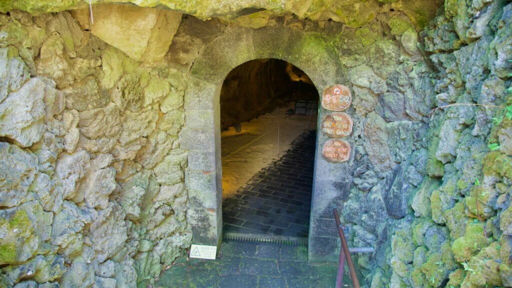 Basalt arch doorway into the lava-tube caves at Hallim Park.