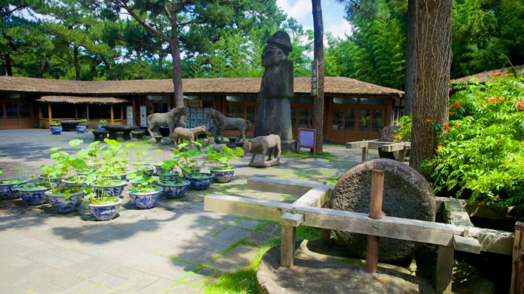 Courtyard with lotus pots, grindstone, and stone figures in Hallim Park.