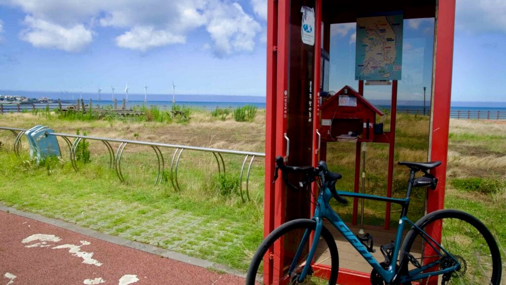 Cycle certification shelter with bike and wind farm view.