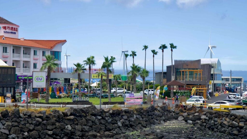 Waterfront shops and palms at Panpo Port, Jeju.