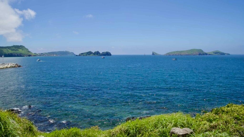 Wide bay view toward Chagwido from a grassy bluff.
