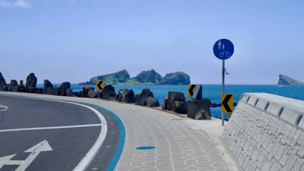 Curving bike path along the seawall with Chagwido offshore.