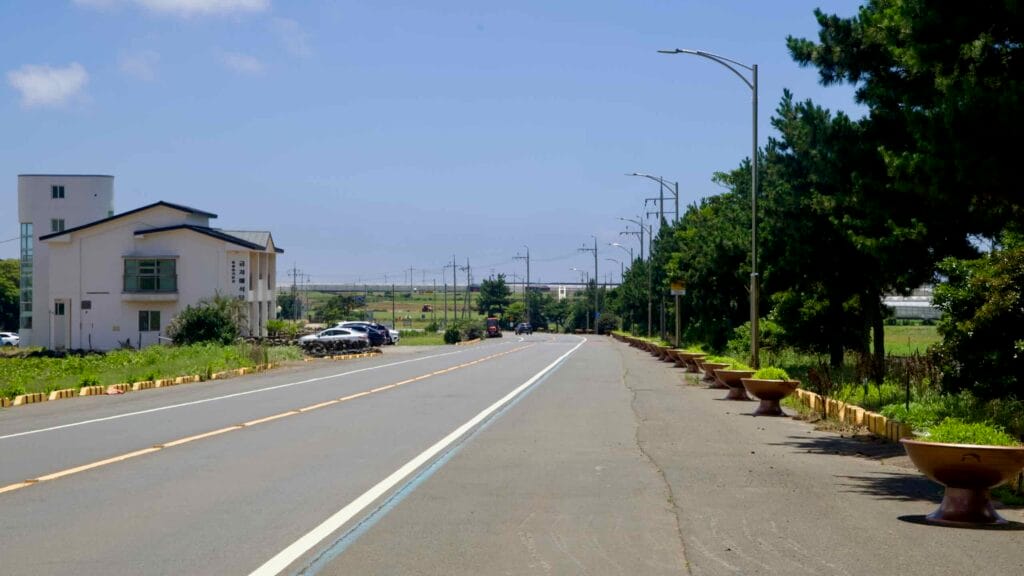 Tourist signs for Suwolbong and the Chocolate Museum beside the bike lane.