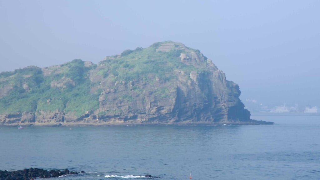 Yongmeori Coast’s green headland across calm water at Sagye.