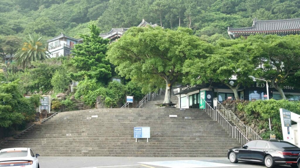 Wide stone steps climb toward Bomunsa Temple below Sanbang Mountain’s green slopes.