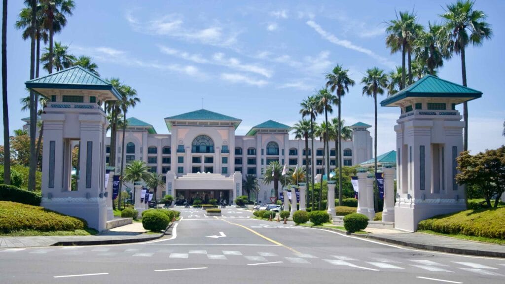 Entrance to Lotte Hotel Jeju framed by palms at Jungmun.