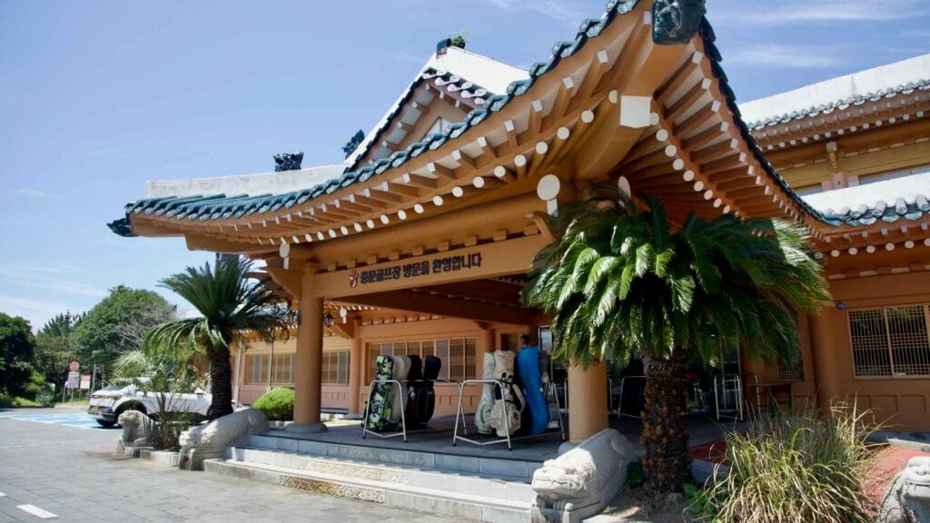 Jungmun Golf Course clubhouse with hanok‑style roof.