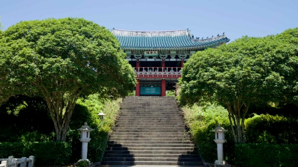 Stone steps lined with trees leading up to Cheonjeru Pavilion at Cheonjeyeon.