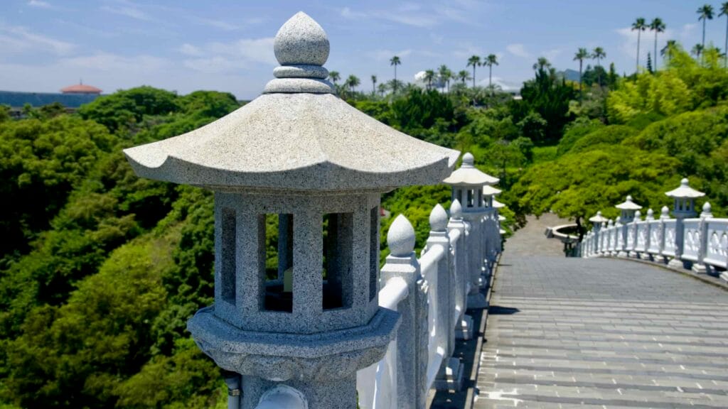 Stone lantern and white balustrade on Seonim‑gyo Bridge at Cheonjeyeon.