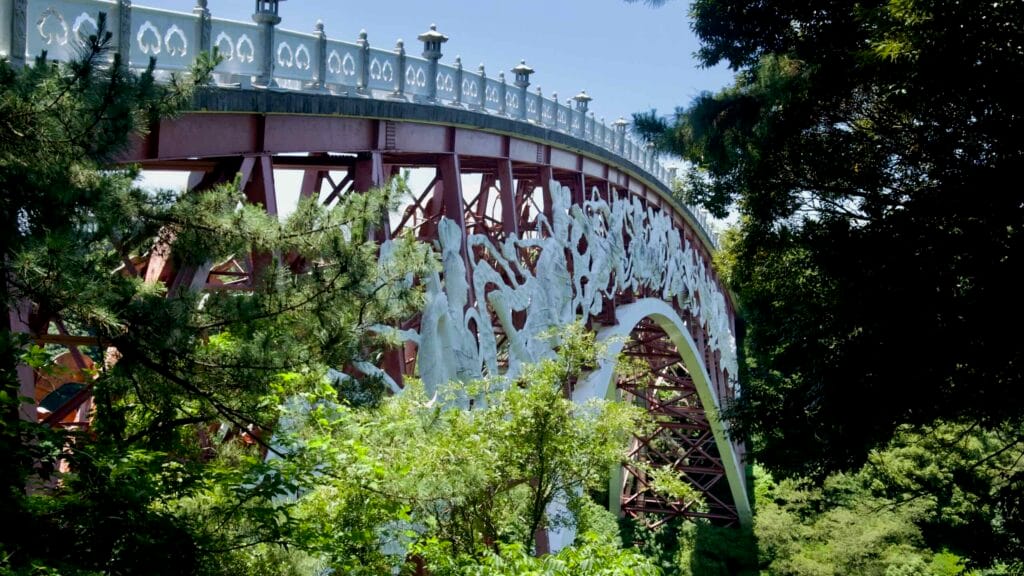 Seonim Bridge’s ornate arch rises above the forest near Cheonjeyeon Falls.