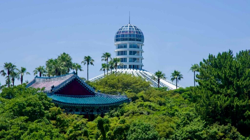 Cheonjeru’s blue tiles and Yeomiji’s glass dome rise above the trees.