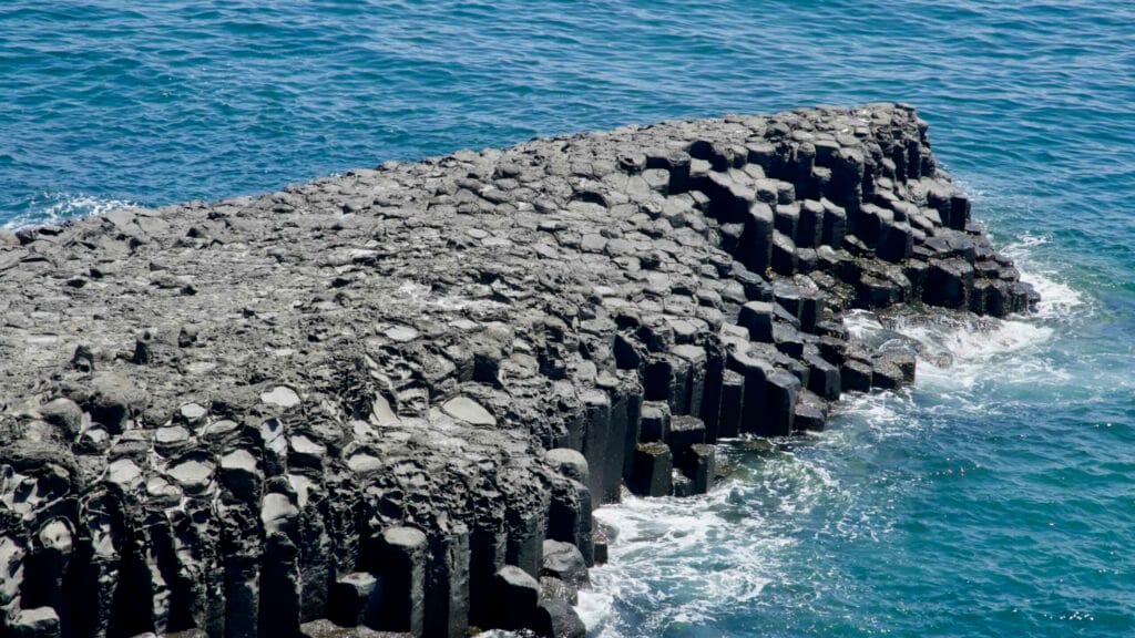 Close-up view of hexagonal basalt columns at Jusangjeolli Cliffs.