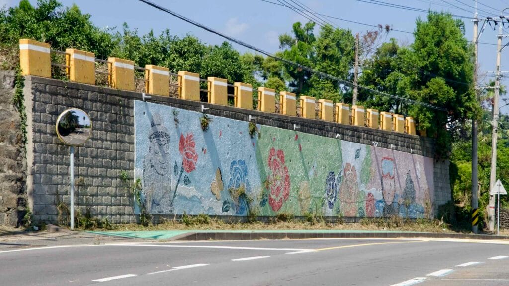 A colorful mosaic decorates a retaining wall beside Ee-eo-do Road in Seogwipo.