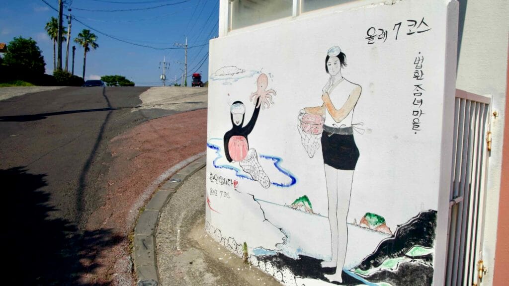 A mural shows Jeju’s haenyeo divers along Olle Trail 7.