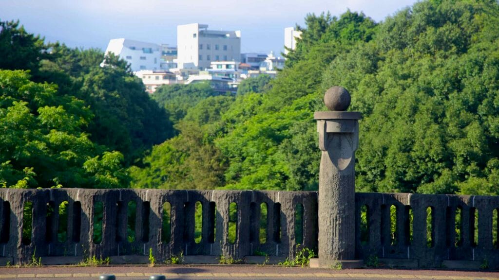 Seogwi Bridge balustrade with downtown Seogwipo on the ridge.