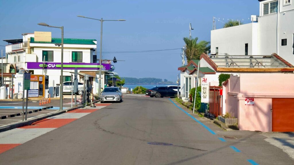 A quiet street and CU store lead down to Jaguri Park’s freshwater beach in Seogwipo.