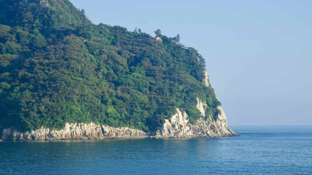 Munseom’s eastern cliffs drop to the blue water below.