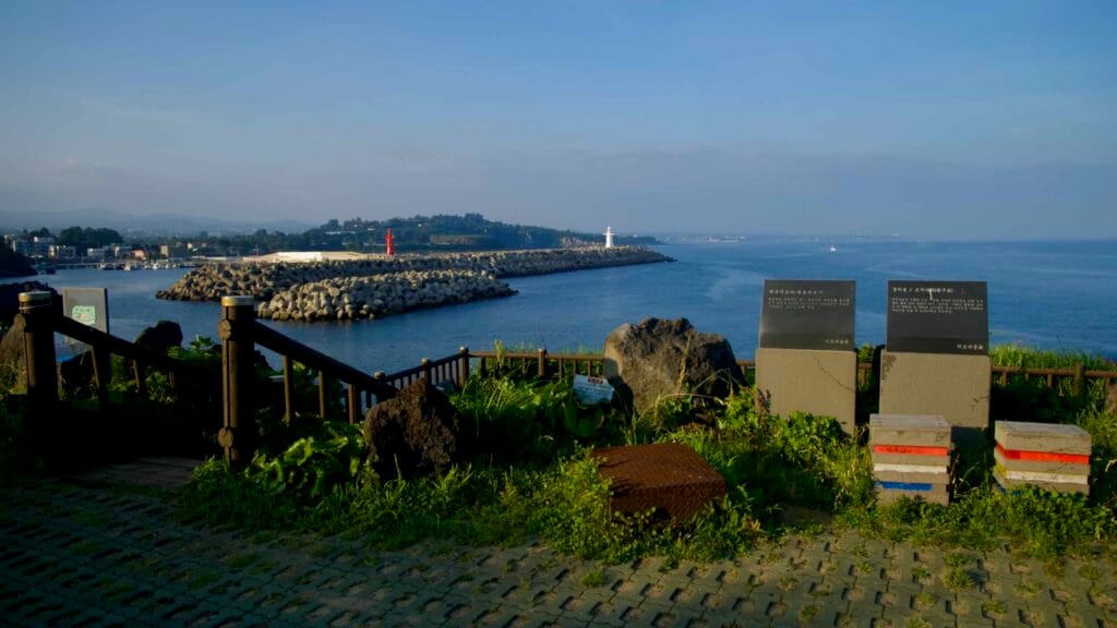 Red and white lighthouses mark Gudumi Port’s breakwaters.