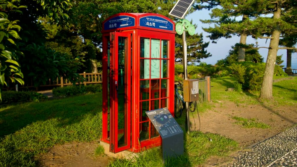 A red cycling certification booth and route map stand in the grass at Soesokkak.