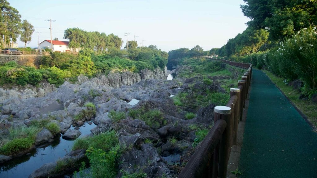 A riverside path follows the Soesokkak gorge beside basalt pools and summer greenery.